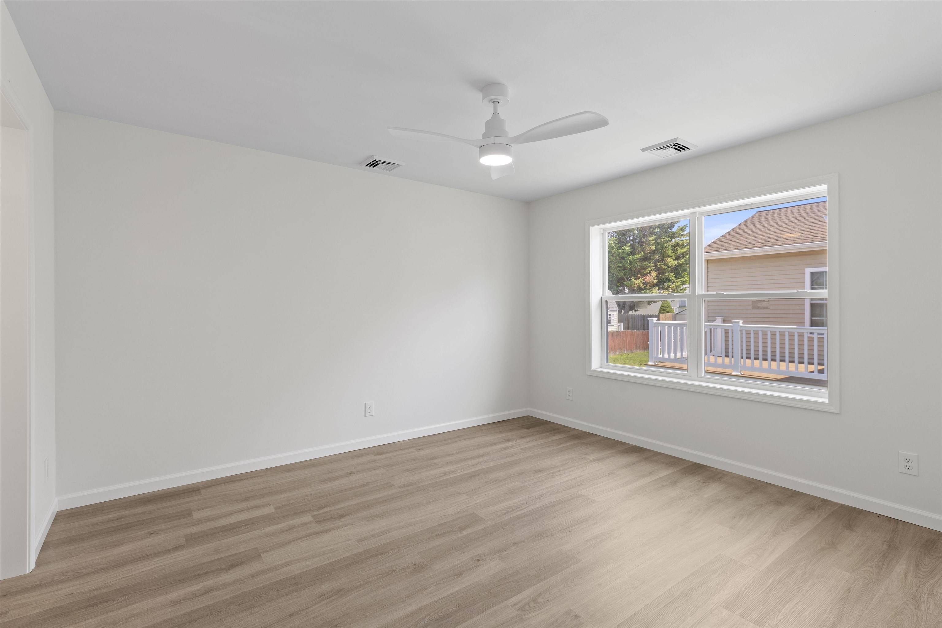 108 Sunray Road Del Haven, NJ 08251 - Photo 10 of 36 an empty room with wooden floor and windows