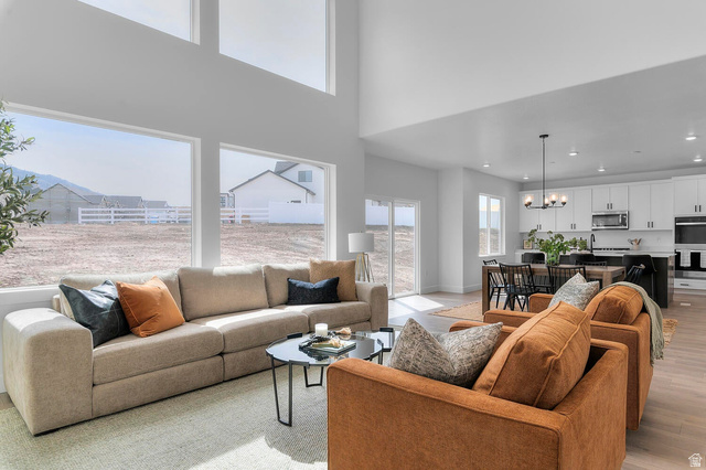 342 North Rhyolite Drive, Unit 88 Hurricane, UT 84737 - Photo 4 of 26 Two-story living area featuring expansive windows, high ceilings, and light wood-finish flooring