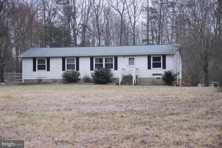 a front view of house with yard and trees