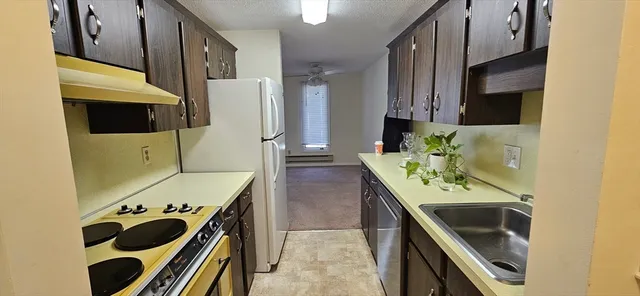 a kitchen with stainless steel appliances kitchen island a stove oven and a refrigerator