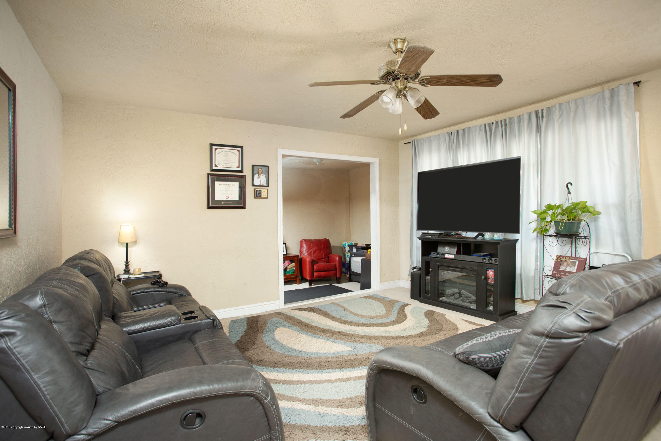 4108 South Lipscomb Street Amarillo, TX 79110 - Photo 4 of 23 a living room with furniture and a flat screen tv
