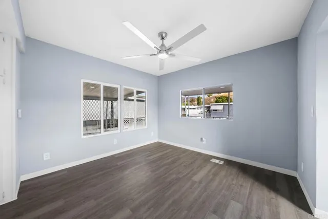 wooden floor in an empty room with a window
