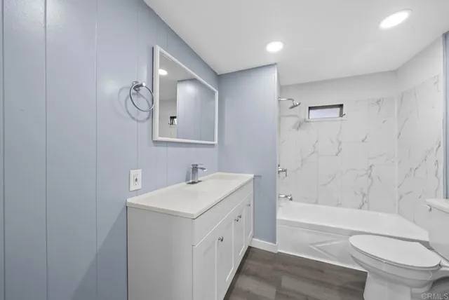 a bathroom with a double vanity sink toilet and shower