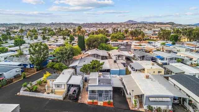 an aerial view of residential houses with city view