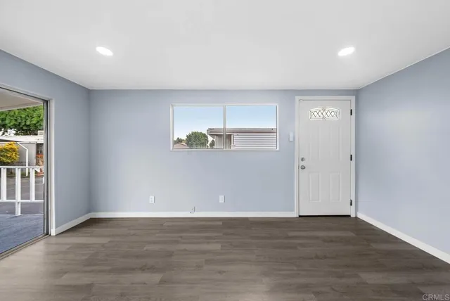 a view of a room with wooden floor and window