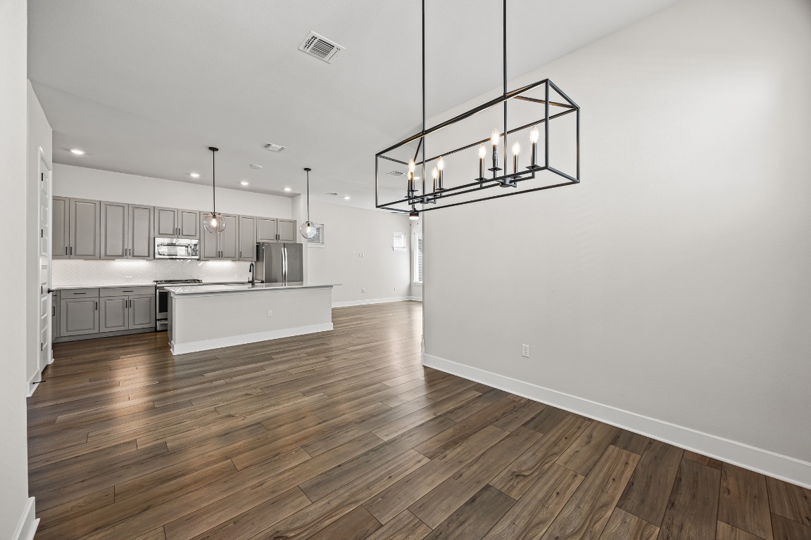 5806 Rangeland Road Austin, TX 78747 - Photo 12 of 33 a view of a kitchen and wooden floor