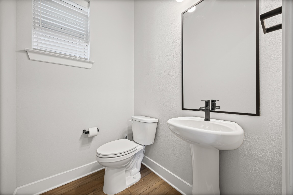 5806 Rangeland Road Austin, TX 78747 - Photo 9 of 33 a bathroom with a toilet sink and mirror