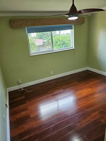 a view of room with window and wooden floor