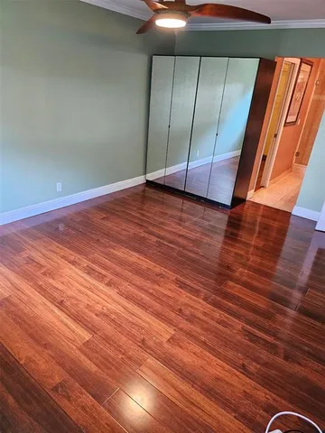 a view of a room with wooden floor