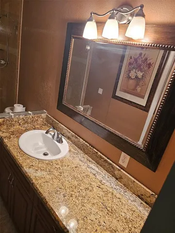 a bathroom with a sink and mirror