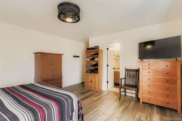 a bedroom with a bed and flat screen tv