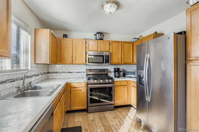 a kitchen with a refrigerator sink and stove