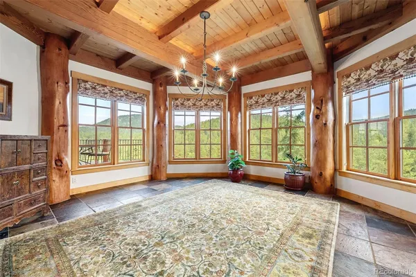 a view of an empty room with a fireplace and windows