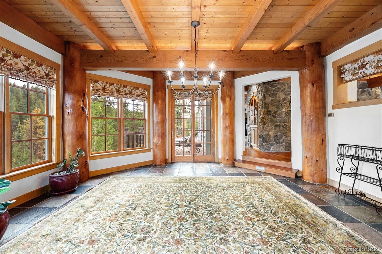 80 Elk Crossing Lane Evergreen, CO 80439 - Photo 13 of 49 a view of an empty room with wooden floor and a window