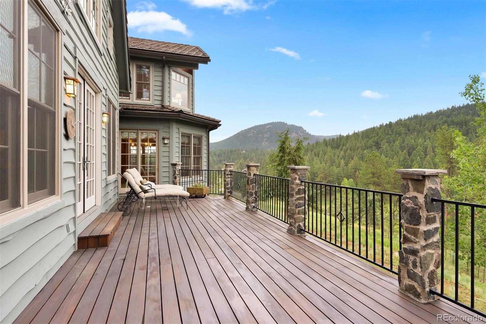 80 Elk Crossing Lane Evergreen, CO 80439 - Photo 14 of 49 a view of a balcony with two chairs and wooden floor