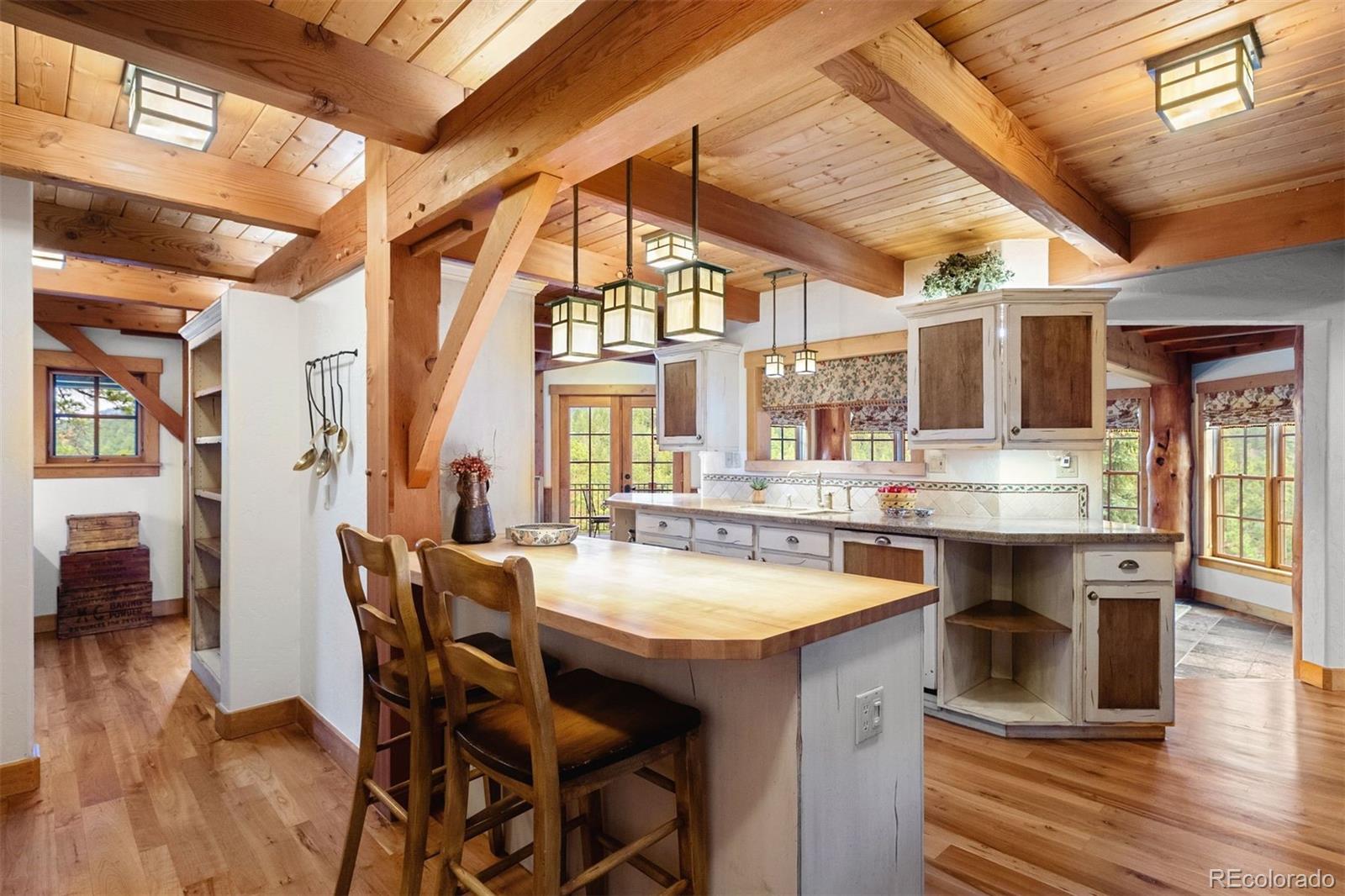 80 Elk Crossing Lane Evergreen, CO 80439 - Photo 15 of 49 a large kitchen with a table and chairs