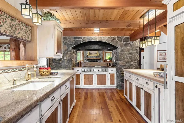 a kitchen with stainless steel appliances granite countertop a stove and a sink