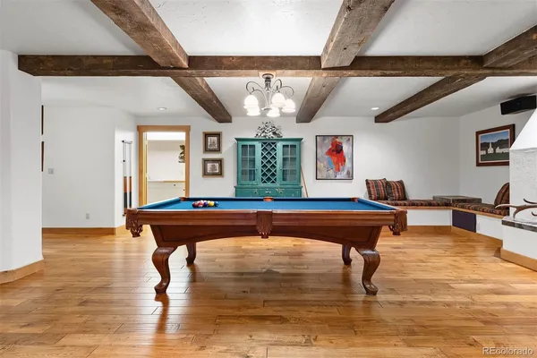 a room with pool table and windows