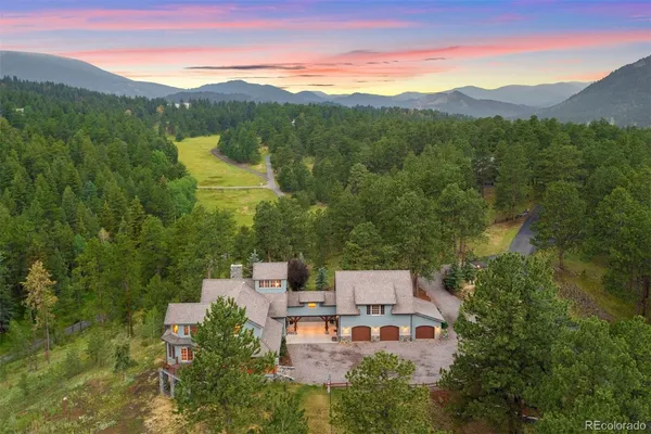 an aerial view of a house with mountain view
