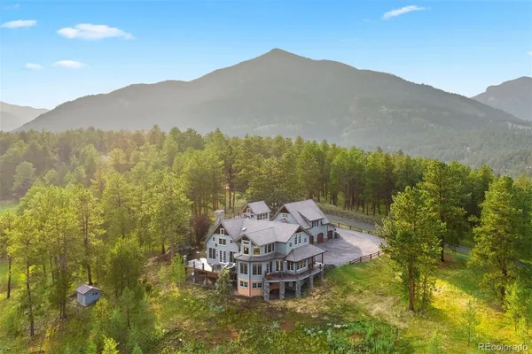 a view of a house with a mountain in the background
