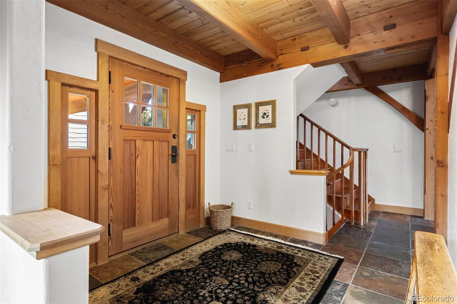 80 Elk Crossing Lane Evergreen, CO 80439 - Photo 6 of 49 a view of a hallway with wooden floor and staircase
