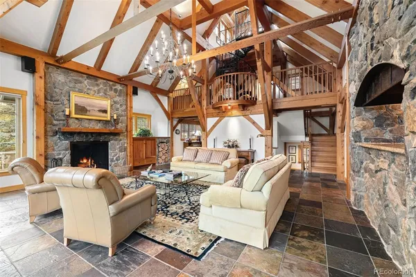 a living room with furniture a fireplace and a table