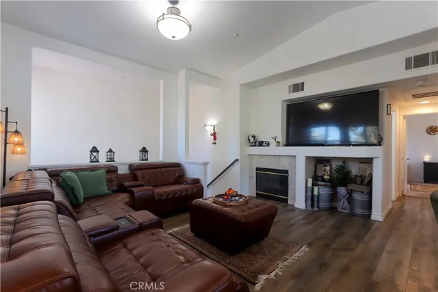 a kitchen with stainless steel appliances granite countertop a refrigerator a stove a sink a dining table and chairs