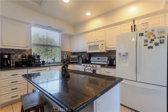 a kitchen with stainless steel appliances granite countertop a stove and a sink