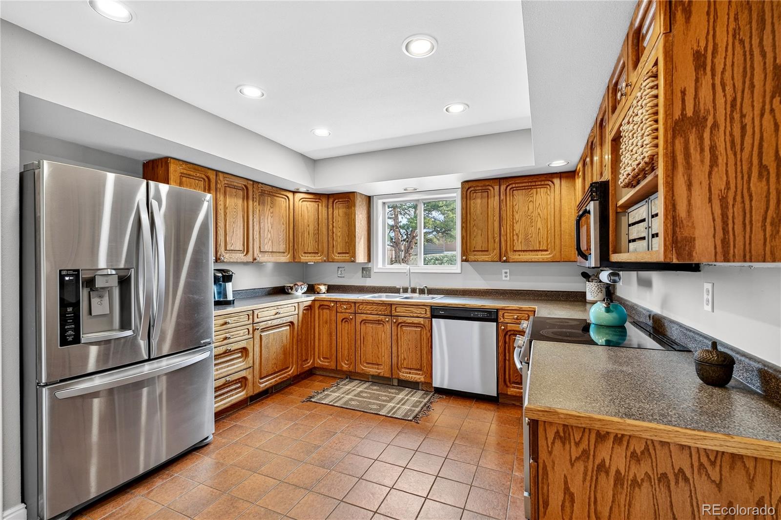 31249 Robinson Hill Road Golden, CO 80403 - Photo 11 of 48 a kitchen with stainless steel appliances granite countertop a refrigerator a stove and a sink