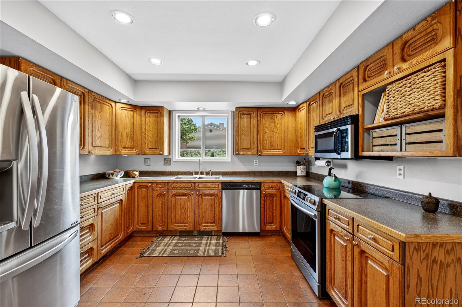 31249 Robinson Hill Road Golden, CO 80403 - Photo 12 of 48 a kitchen with stainless steel appliances granite countertop sink stove top oven and refrigerator