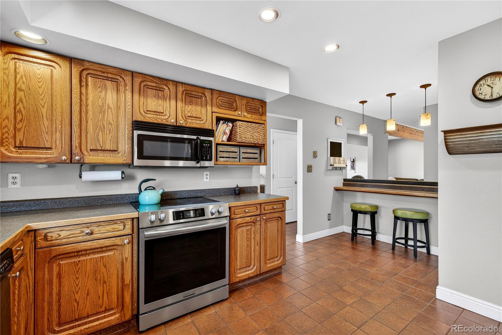 31249 Robinson Hill Road Golden, CO 80403 - Photo 13 of 48 a kitchen with stainless steel appliances granite countertop a stove top oven microwave and cabinets