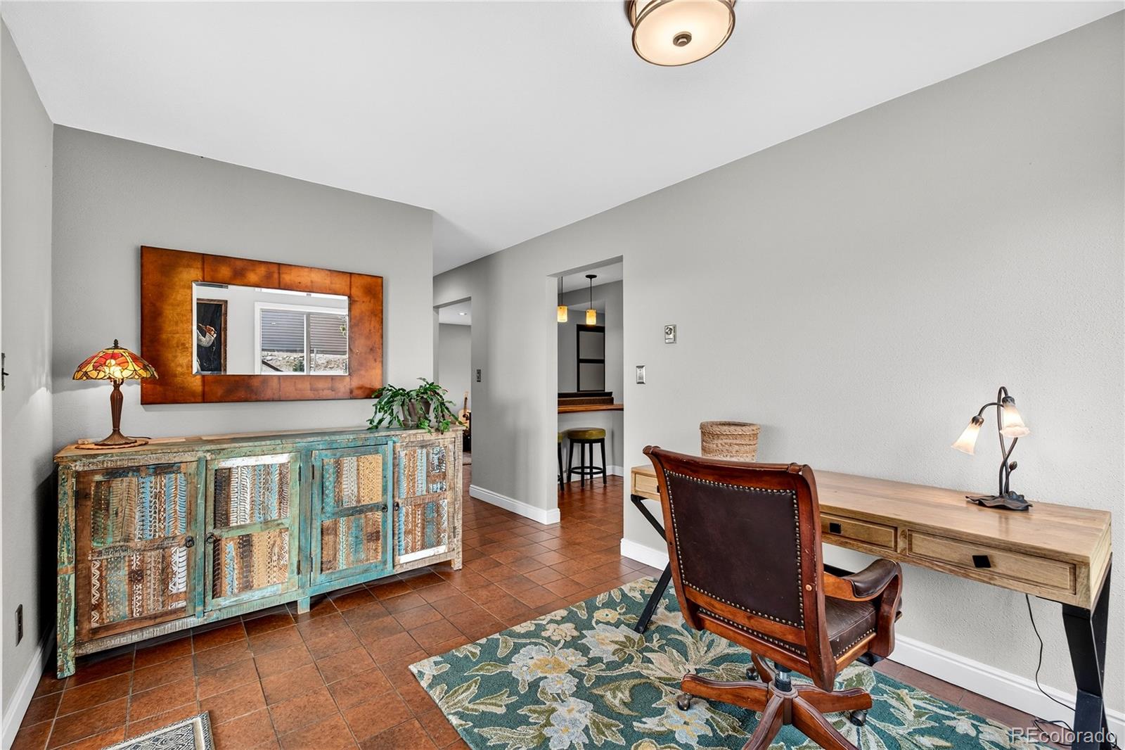 31249 Robinson Hill Road Golden, CO 80403 - Photo 16 of 48 a bedroom with furniture and wooden floor