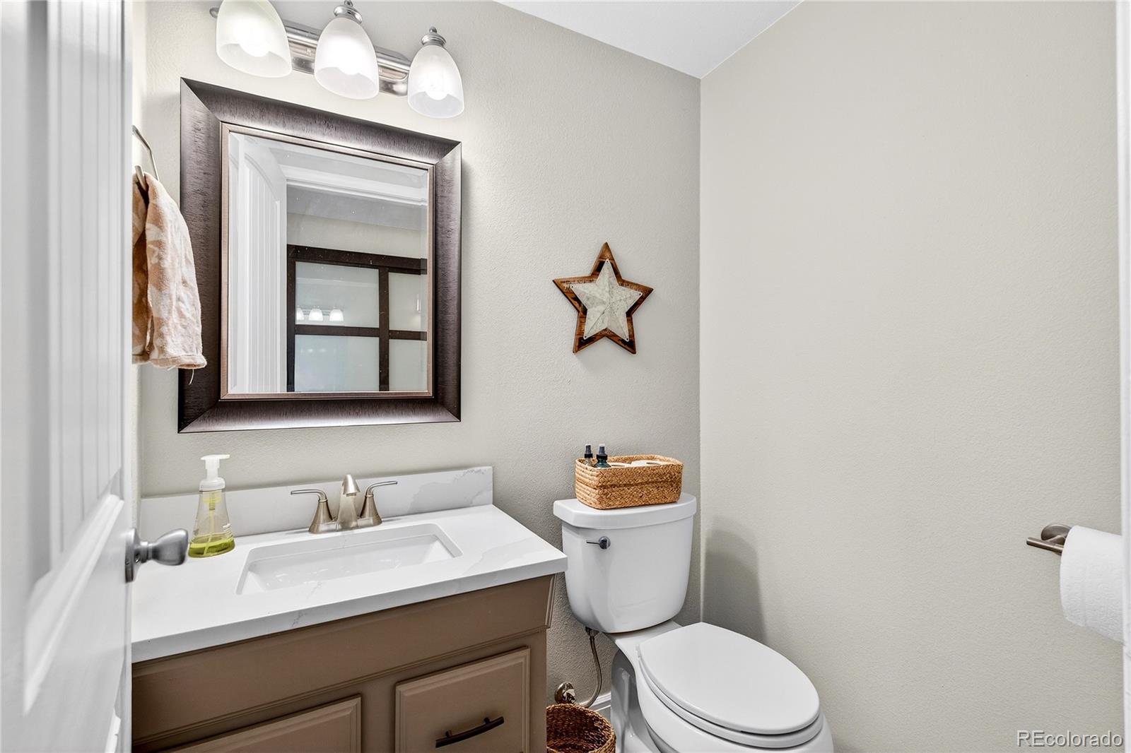 31249 Robinson Hill Road Golden, CO 80403 - Photo 17 of 48 a bathroom with a granite countertop toilet sink and mirror