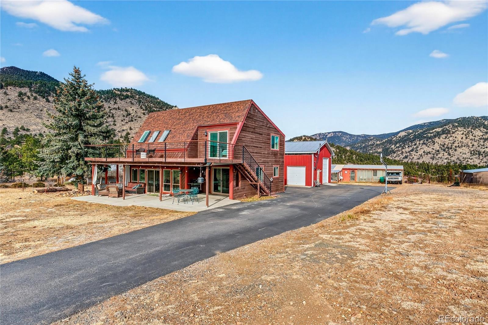 31249 Robinson Hill Road Golden, CO 80403 - Photo 2 of 48 a front view of a house with a yard