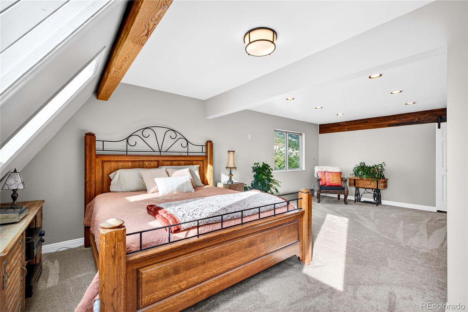 31249 Robinson Hill Road Golden, CO 80403 - Photo 21 of 48 a bedroom with a bed and a couch