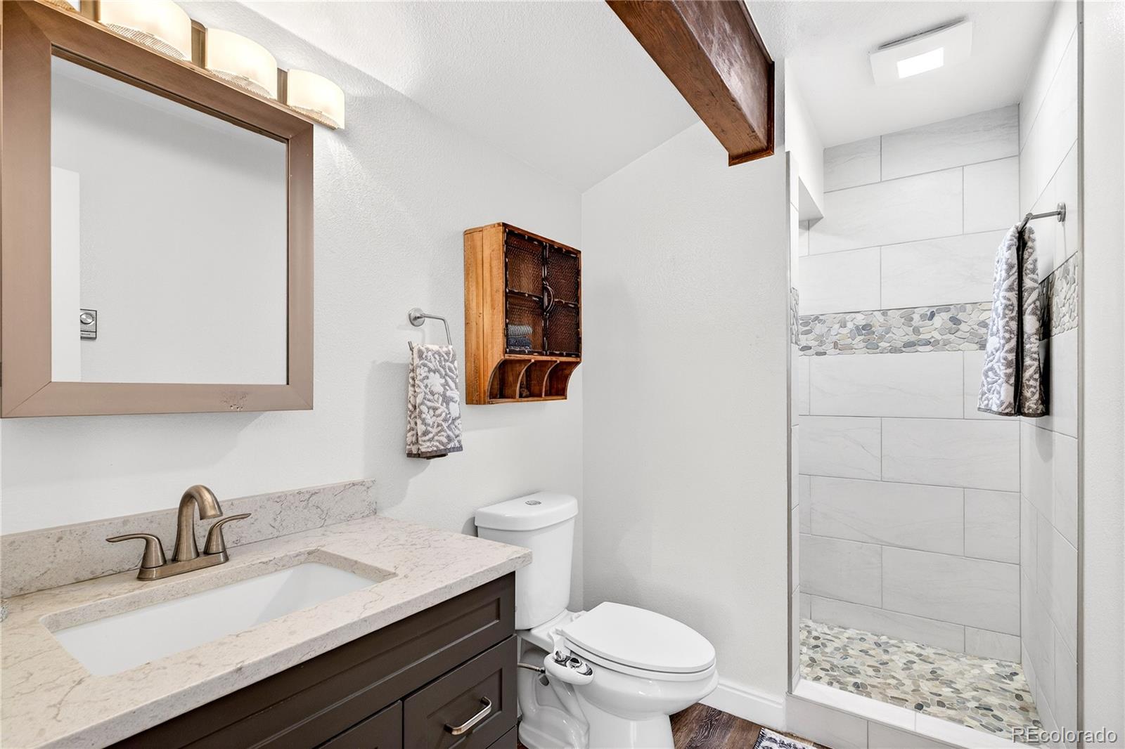 31249 Robinson Hill Road Golden, CO 80403 - Photo 22 of 48 a bathroom with a granite countertop sink toilet and shower