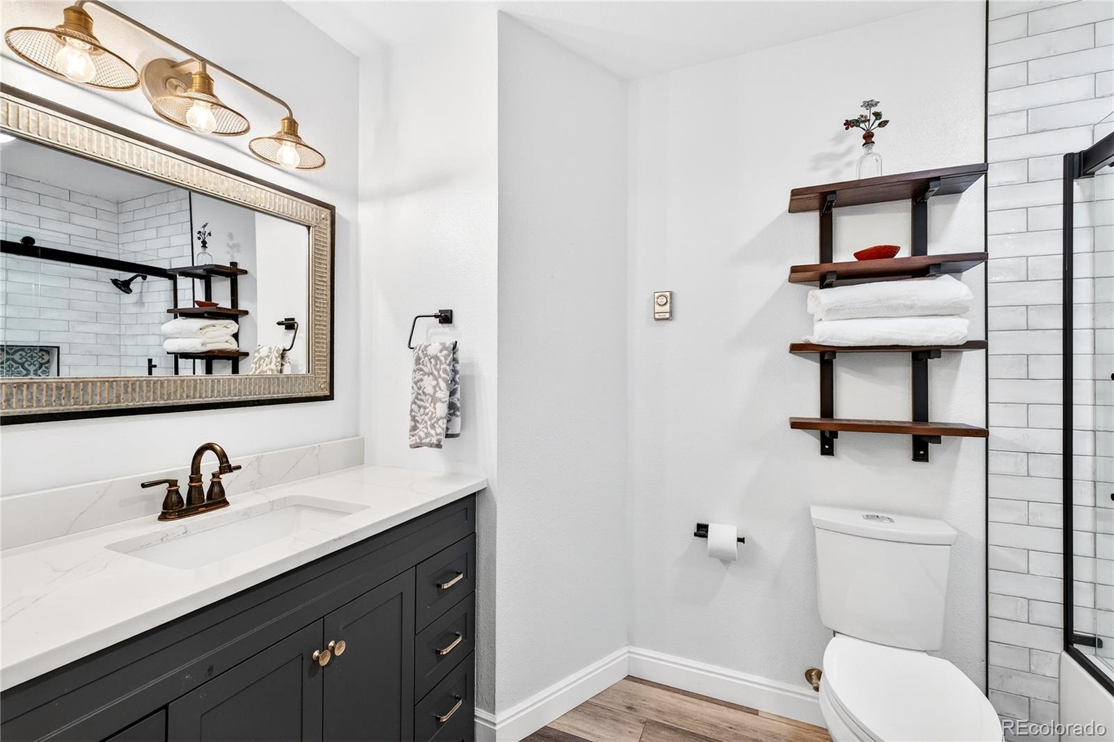 31249 Robinson Hill Road Golden, CO 80403 - Photo 25 of 48 a bathroom with a toilet sink and mirror