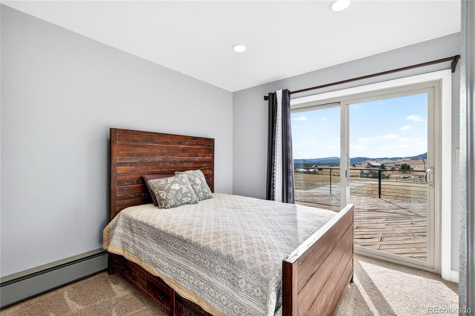 31249 Robinson Hill Road Golden, CO 80403 - Photo 27 of 48 a bedroom with a bed and glass door