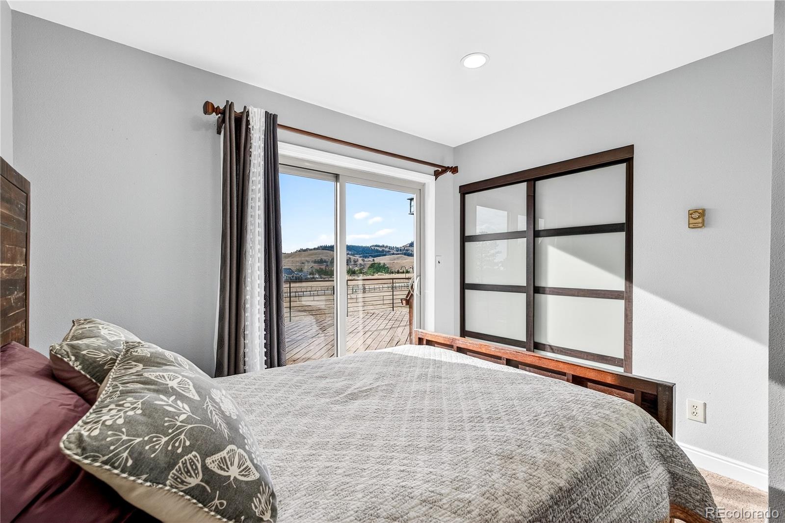31249 Robinson Hill Road Golden, CO 80403 - Photo 28 of 48 a bedroom with a bed and a large window
