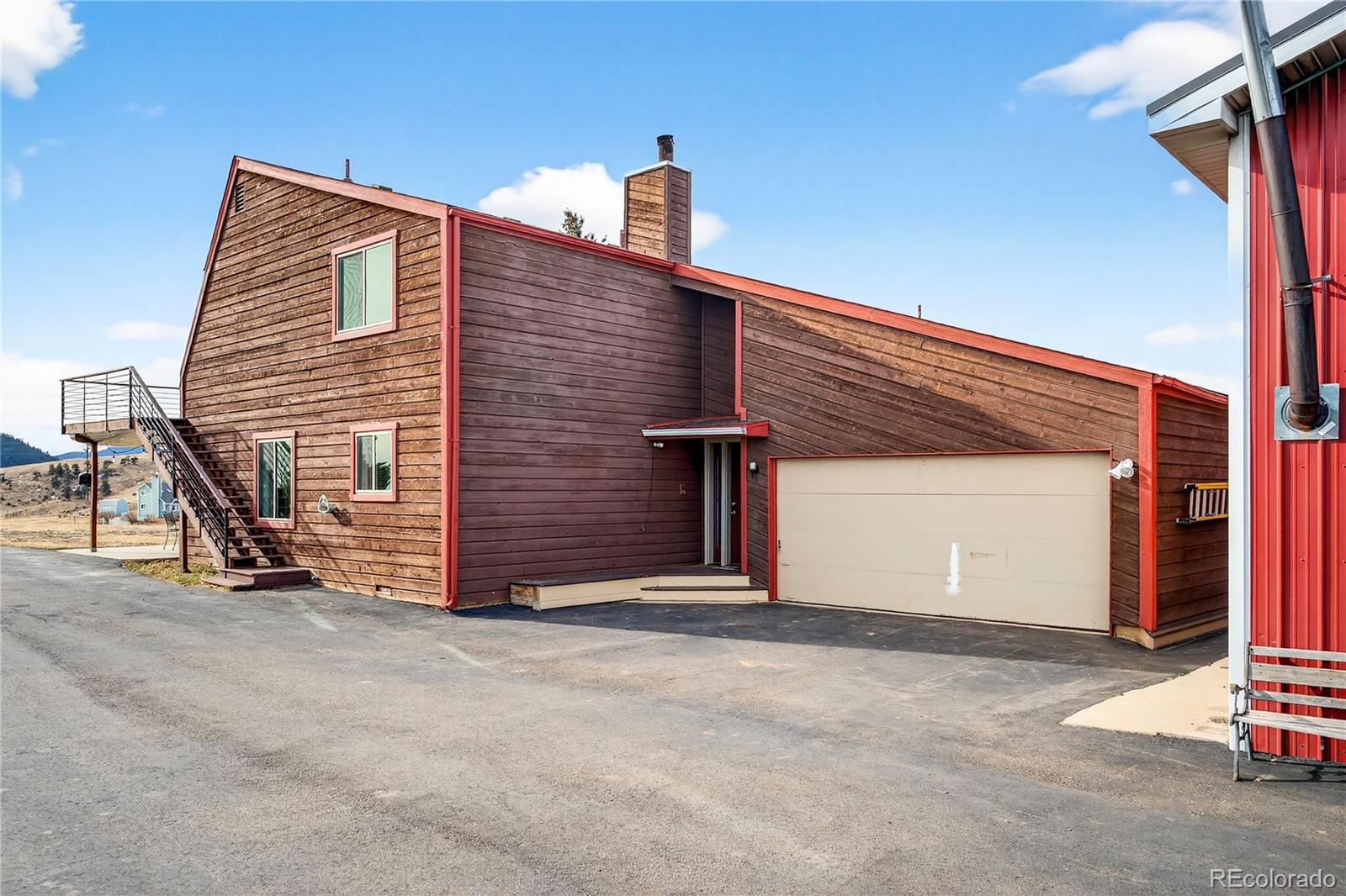 31249 Robinson Hill Road Golden, CO 80403 - Photo 33 of 48 a front view of a house with a garage