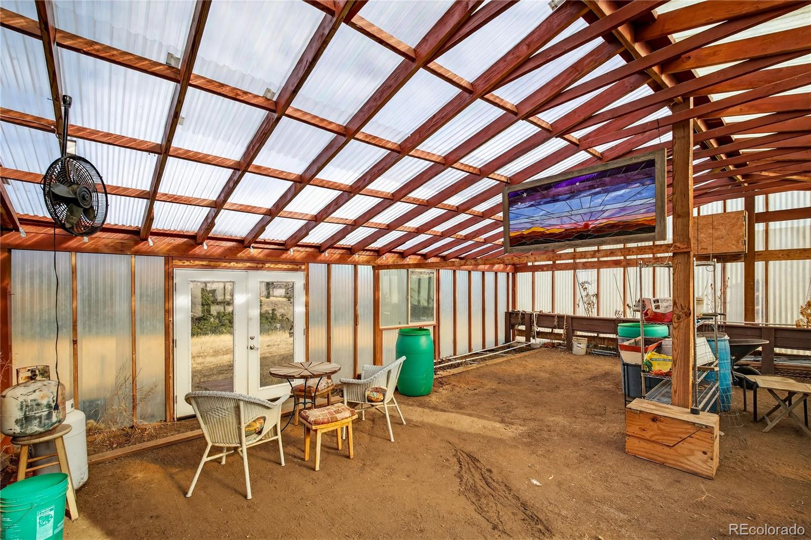 31249 Robinson Hill Road Golden, CO 80403 - Photo 38 of 48 a dining room with furniture water view and large windows