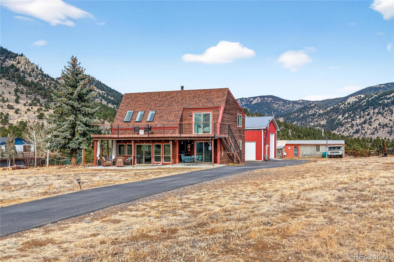 31249 Robinson Hill Road Golden, CO 80403 - Photo 5 of 48 a front view of a house with a yard