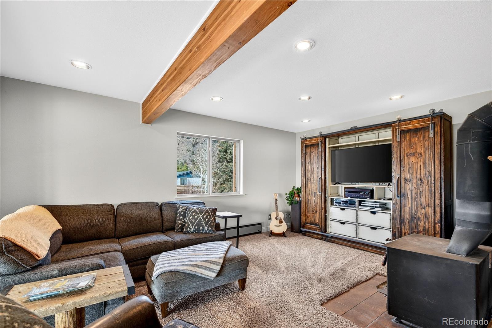 31249 Robinson Hill Road Golden, CO 80403 - Photo 7 of 48 a living room with furniture and a flat screen tv