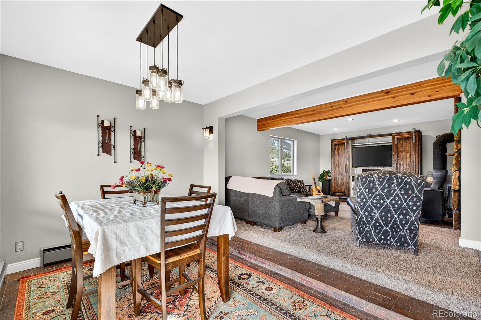 31249 Robinson Hill Road Golden, CO 80403 - Photo 9 of 48 a dining room with furniture a rug and wooden floor