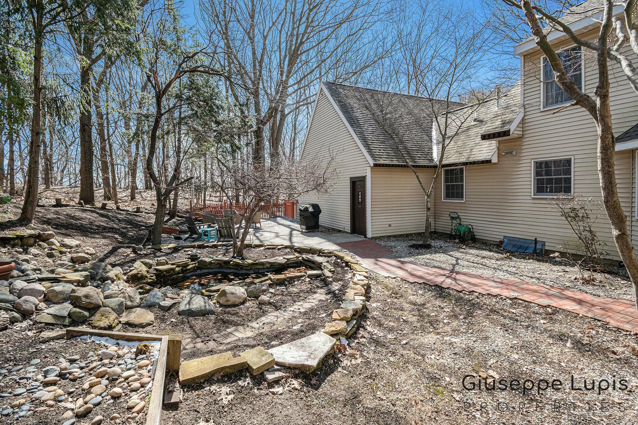 309 Stickney Ridge Road Grand Haven, MI 49417 - Photo 49 of 62 patio/pond