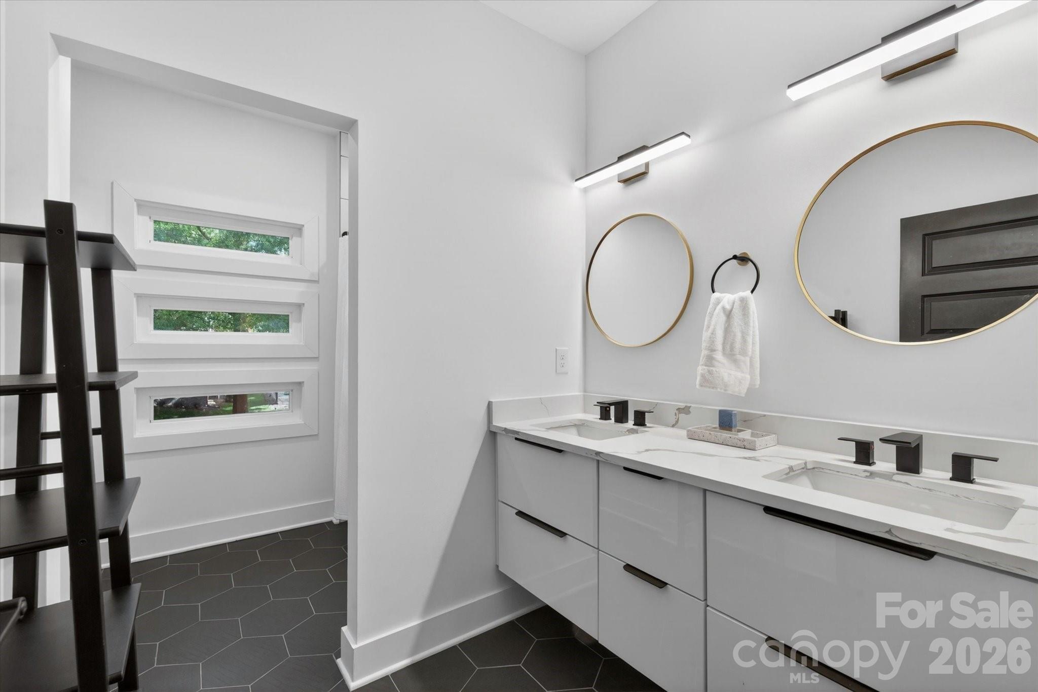 1608 Chippendale Road Charlotte, NC 28205 - Photo 45 of 46 a bathroom with a double vanity sink and a mirror