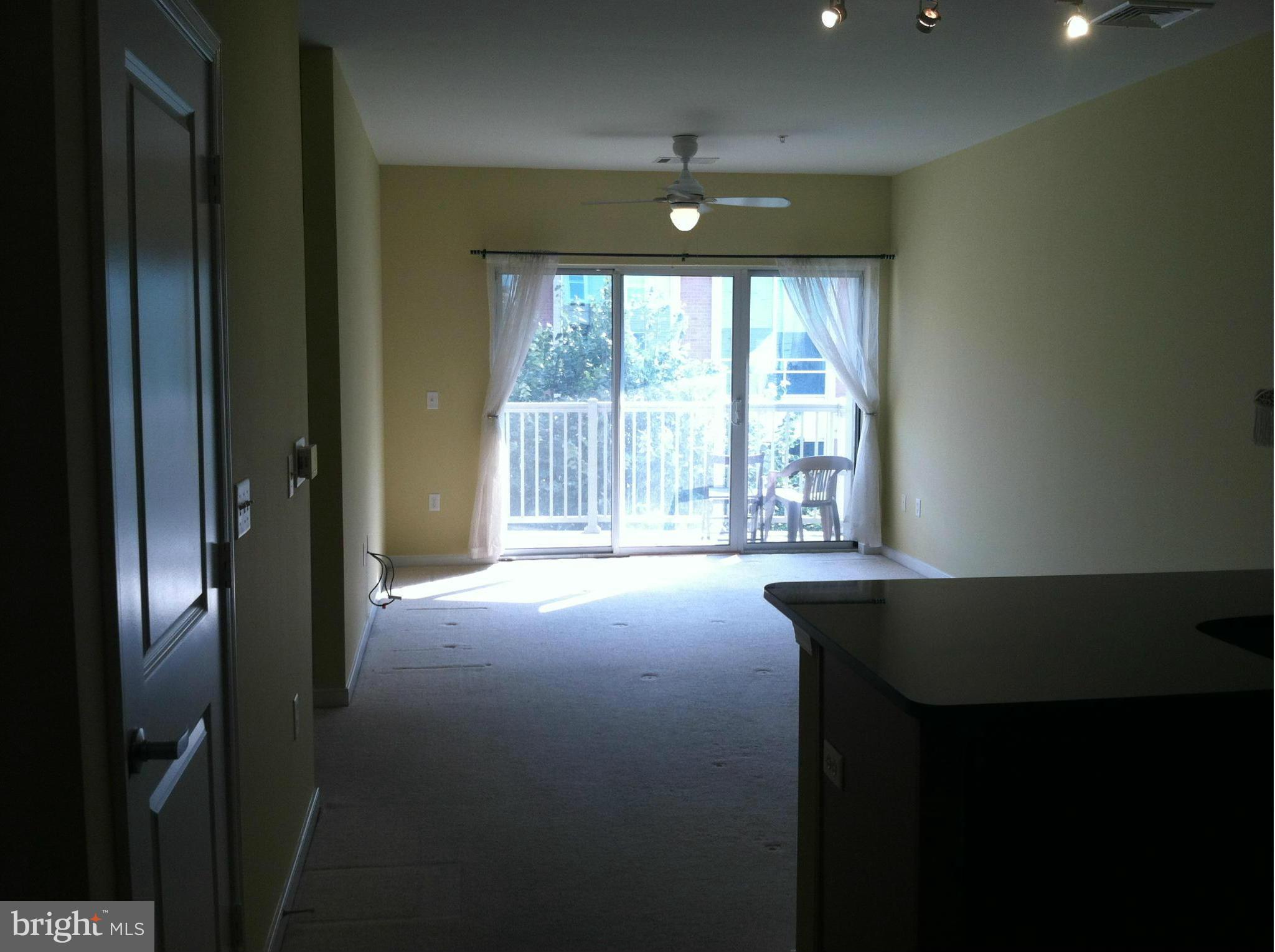 8045 Newell Street, Unit 203 Silver Spring, MD 20910 - Photo 6 of 11 a view of an empty room with a window