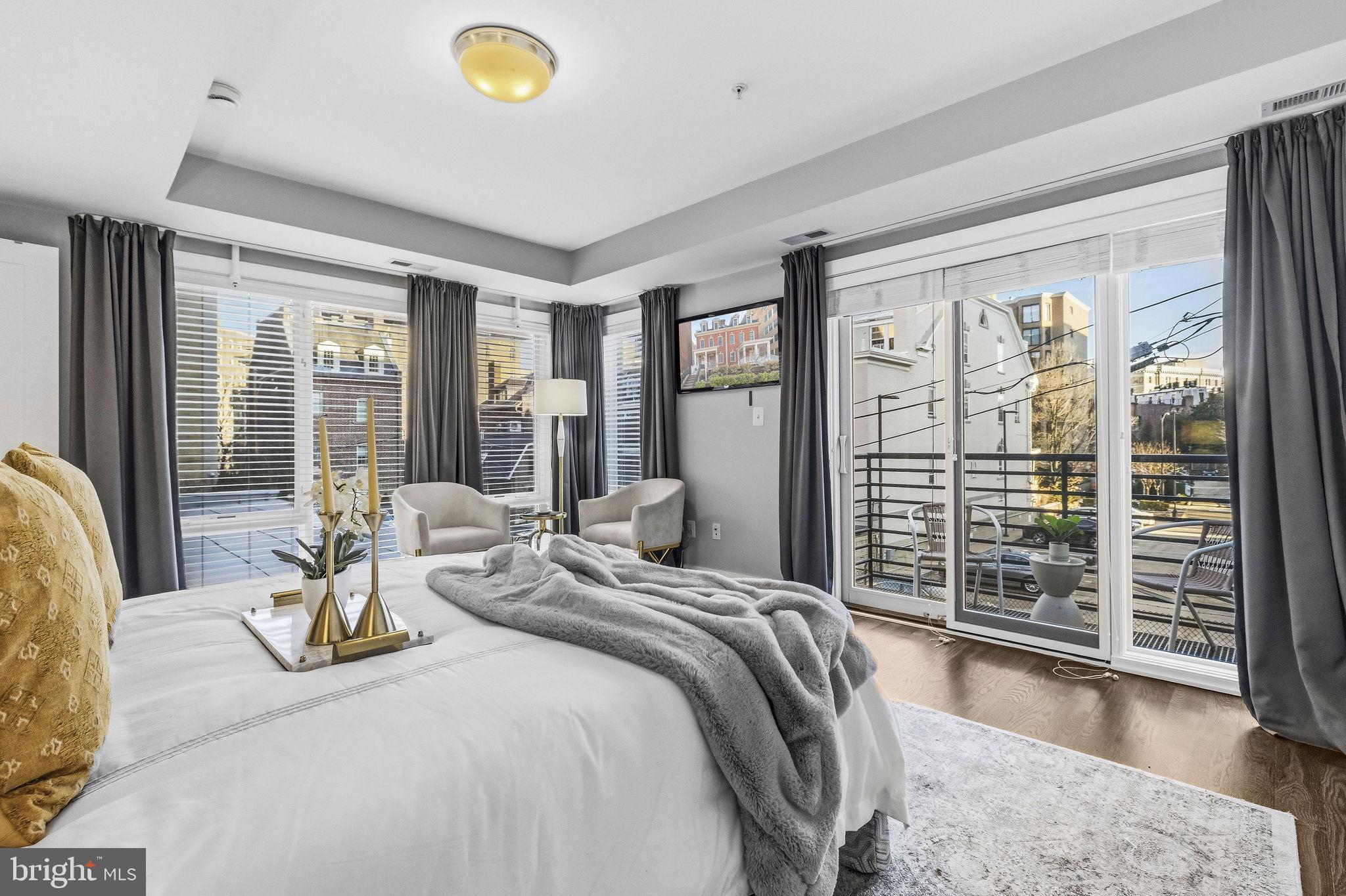 2012 Kalorama Road Northwest, Unit 8 Washington, DC 20009 - Photo 14 of 25 a bedroom with a large bed and large windows