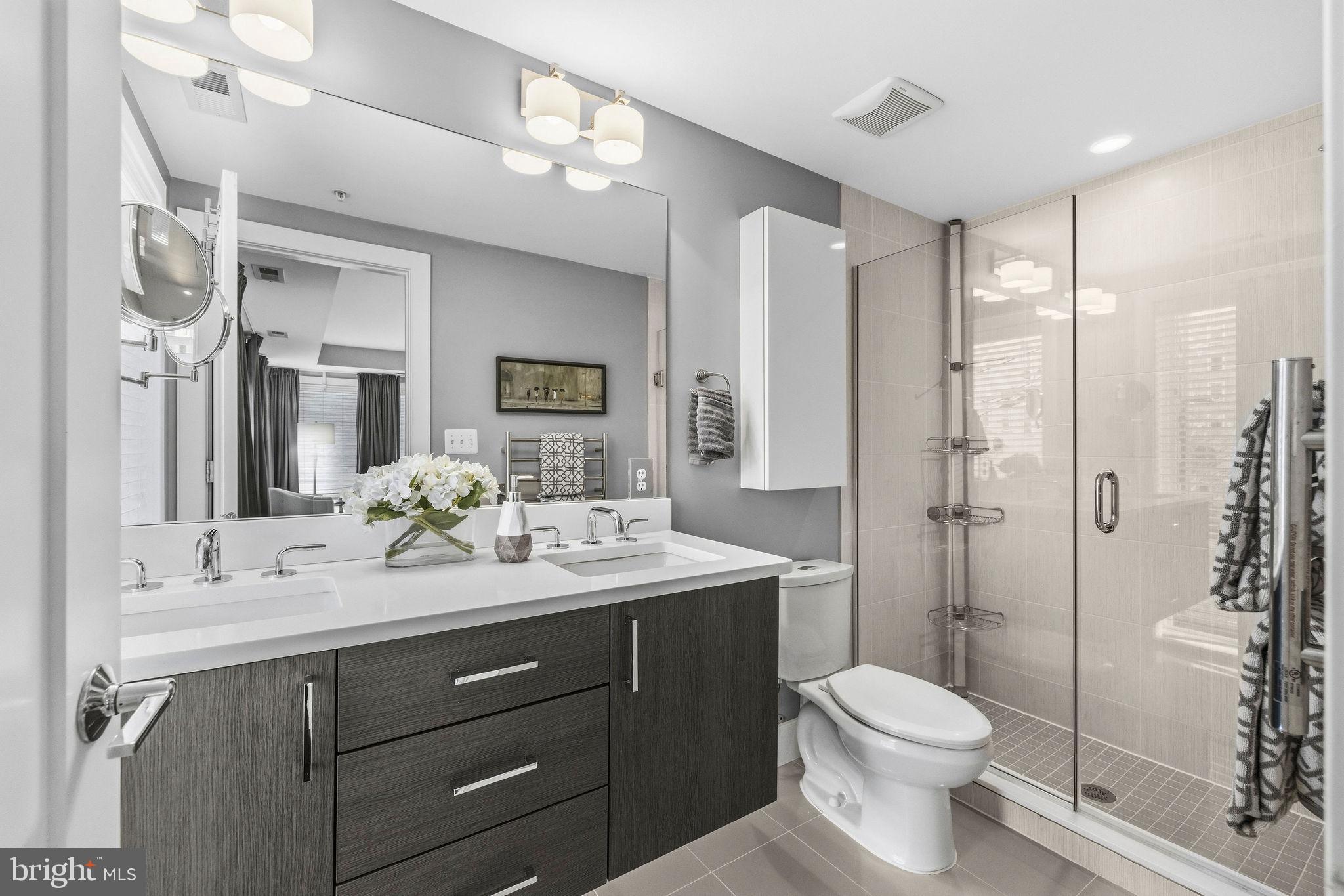 2012 Kalorama Road Northwest, Unit 8 Washington, DC 20009 - Photo 16 of 25 a bathroom with a toilet a sink a glass door a shower a mirror and vanity