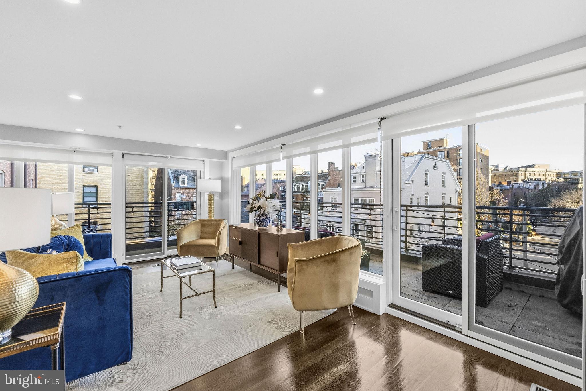 2012 Kalorama Road Northwest, Unit 8 Washington, DC 20009 - Photo 18 of 25 a living room with furniture a flat screen tv and a floor to ceiling window